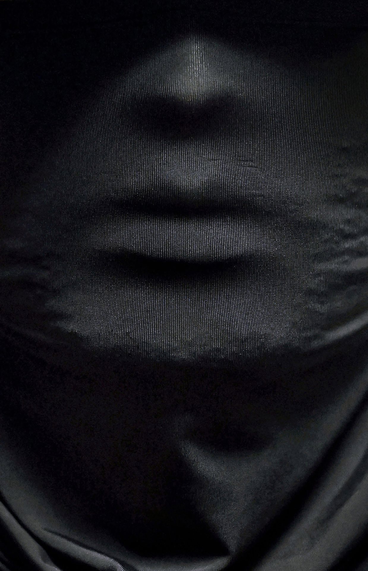 A masked federal officer waits outside a courtroom at the Jacob K. Javits Federal Building in New York City, New York. Following 2025 policy shifts, ICE agents utilize target photographs to identify and detain migrants immediately after their hearings, turning the courthouse into a primary site for removal.